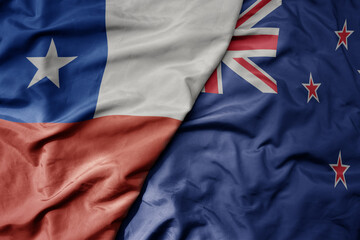 big waving national colorful flag of new zealand and national flag of chile .