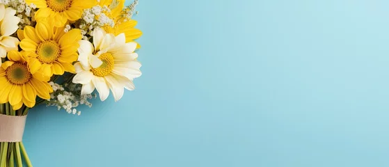 Poster Im Rahmen Bouquet of yellow flower on pastel blue background. © neirfy