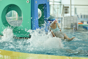 The kids playing in the pool Splashes from jumping