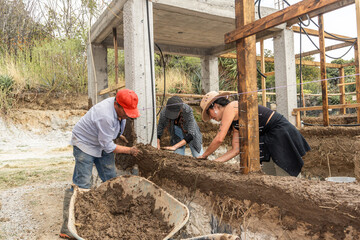  Community Architecture: Volunteers create a mud house, joining forces concept of sustainability,Sustainability,house,Community,volunteers
