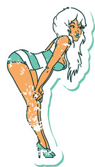 distressed sticker tattoo style icon  of a pinup girl in swimming costume