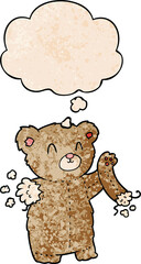 cartoon teddy bear with torn arm and thought bubble in grunge texture pattern style