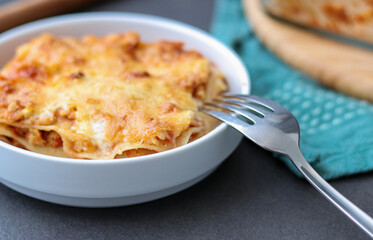 Homemade vegan Lasagne with soy meat and vegan cheese on a white plate