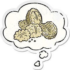 cartoon walnuts and thought bubble as a distressed worn sticker