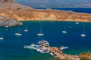Sea pier with ships in the city of Lindos in Rhodes.