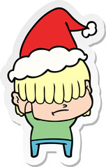 sticker cartoon of a boy with untidy hair wearing santa hat