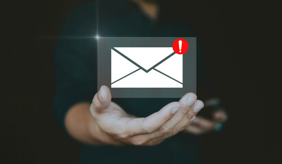 Email alert concept with warning and email notification on hand.