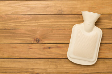 Rubber water warmer bag on wooden background