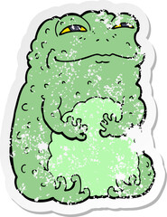 Naklejka premium distressed sticker of a cartoon smug toad