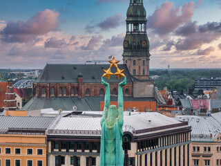 Beautiful sunrise view over Riga by the statue of liberty - Milda in Latvia. The monument of...