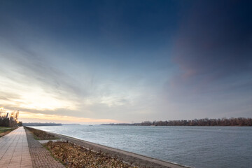 Selective blur on the panorama of dunav river, or danube, on the pedestrian waterfront of the Danube quay in Belgrade, Serbia, at dusk in winter in front of the Danube river.