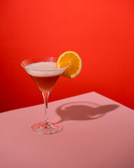Red and Pink Cocktail with a Slice of Orange