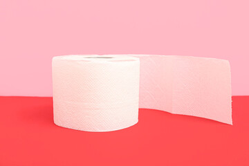 Roll of toilet paper on colorful background