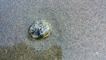 River stone on sand