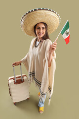Beautiful woman in sombrero hat, with suitcase and Mexican flag on green background