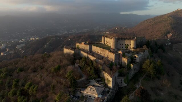 Forte Sperone on a hill during sunset, overlooking Genoa, aerial view