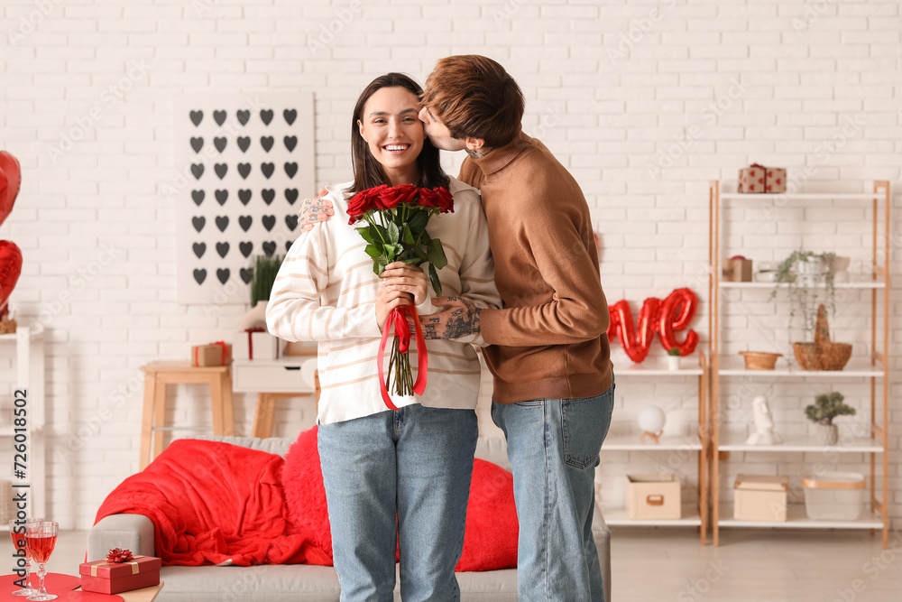 Canvas Prints Young couple with bouquet of roses having date at home. Valentine's day celebration