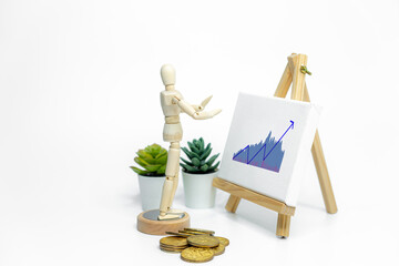 Mannequin drawing a graph charts on easel; isolated on white background; Business or finance concept