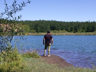 latin man on the shore of a lake
