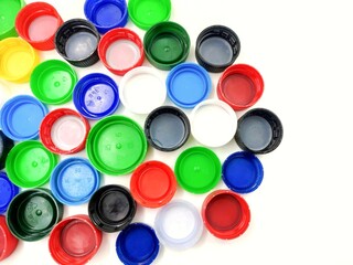 A variety of multicolored plastic caps. Concept picture of damage to the environment caused by waste and plastic.