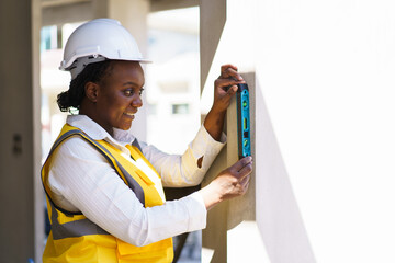 Female engineer or foreman uses water level measurement ruler.