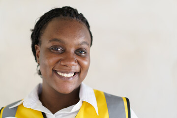 Portrait of African - American black ethnicity engineer - contractor in safety suit and helmet...