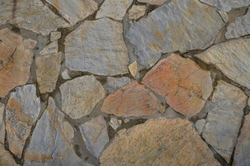 wall made of real stone as a background in the sun 12