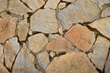 wall made of real stone as a background in the sun 11