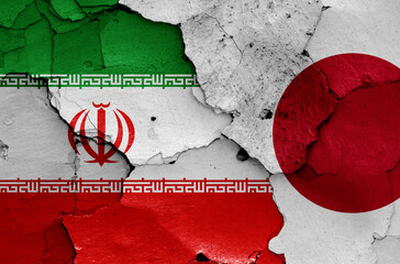 flags of Iran and Japan painted on cracked wall