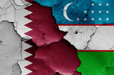 flags of Qatar and Uzbekistan painted on cracked wall