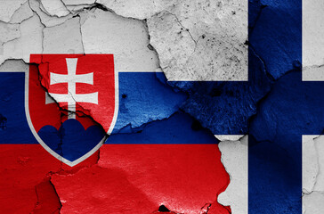 flags of Slovakia and Finland painted on cracked wall
