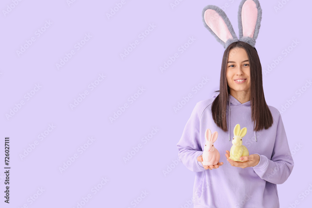 Poster young woman in bunny ears with easter rabbits on lilac background