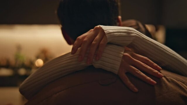 Loving wife hugging husband for neck dancing together at dark apartment close up