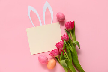 Creative composition with blank card, tulips and egg on pink background. Easter celebration