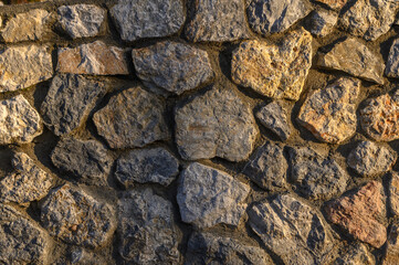 wall made of real stone as a background in the sun 6