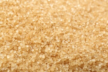 Granulated brown sugar as background, closeup view