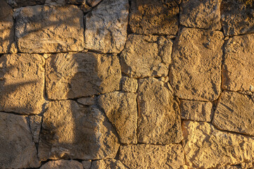 Fototapeta premium wall made of real stone as a background in the sun 3