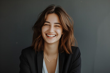 a woman smiling over gray background 