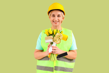 Mature female worker with tulips on green background. International Women's Day celebration