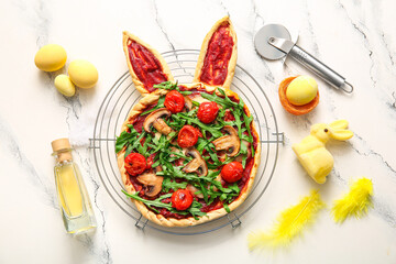 Composition with tasty pizza and Easter eggs on white marble background