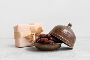 Gift box with dried dates for Ramadan on white table