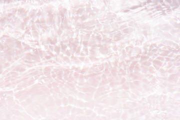 White water with ripples on the surface. Defocus blurred transparent white colored clear calm water surface texture with splashes and bubbles. Water waves with shining pattern texture background.