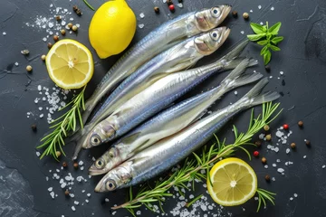 Poster Top view of fresh healthy seafood smelt and sardines with lemon thyme rosemary and sea salt © VolumeThings