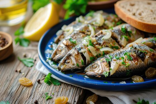 Venetian dish with marinated sardines white onions wine vinegar raisins pine nuts served on a blue wooden table