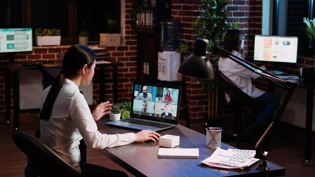 Businesswoman talking with board of directors during business meeting on videocall in office. Employee speaking in remote videoconference telework call, receiving feedback from management