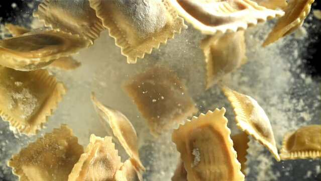 Italian ravioli fly up and fall down with flour. Filmed on a high-speed camera at 1000 fps. High quality FullHD footage