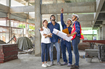 happy family visiting and talking to contractor at site,engineer or architect explain progress of a...