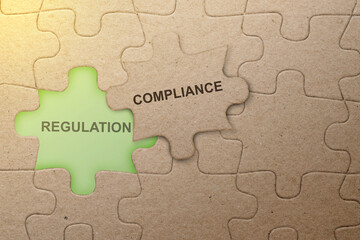 Piece of missing jigsaw puzzle with compliance text