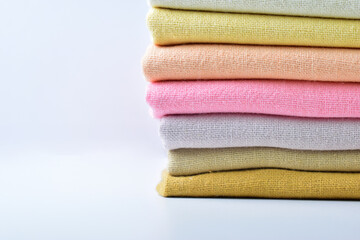 Obraz na płótnie Canvas stack of colourful cotton clothes, pile of clothing on white background