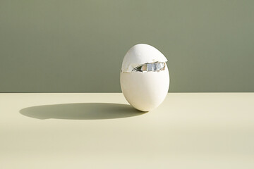Cracked easter egg. Minimalist creative still life.